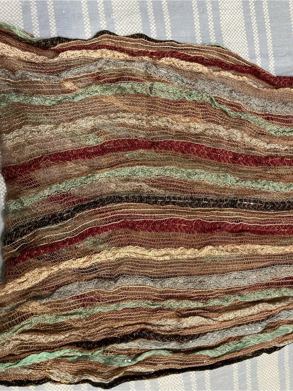 Designer earth toned scarf with fringed bottom.